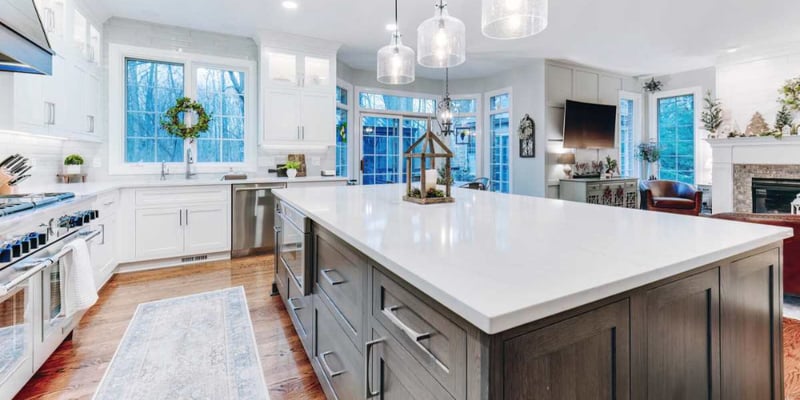 Bright custom kitchen remodel with white cabinets and large island