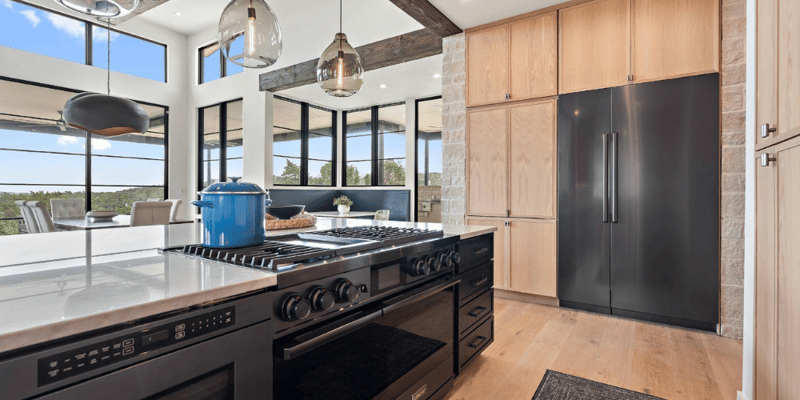 Design-Builder Creates Beautiful Open Space Kitchen with Modern Wood Cabinetry and Floor to Ceiling Windows