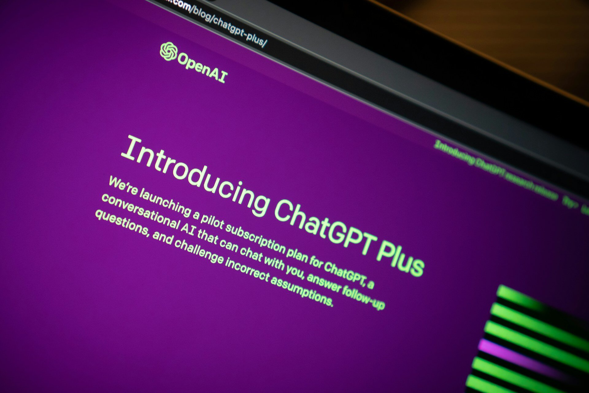 Introducing ChatGPT Plus subscription on OpenAI website, displayed on a laptop screen with a vibrant purple background