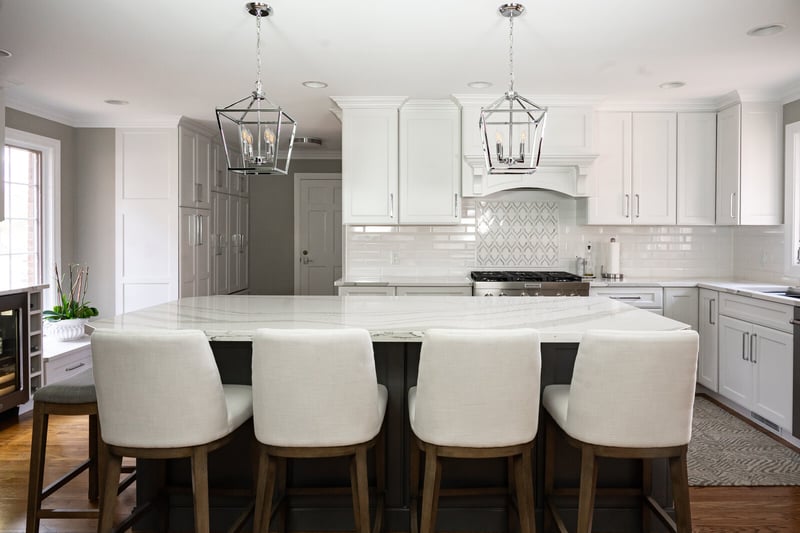 bright white kitchen remodel with white bar stools at island