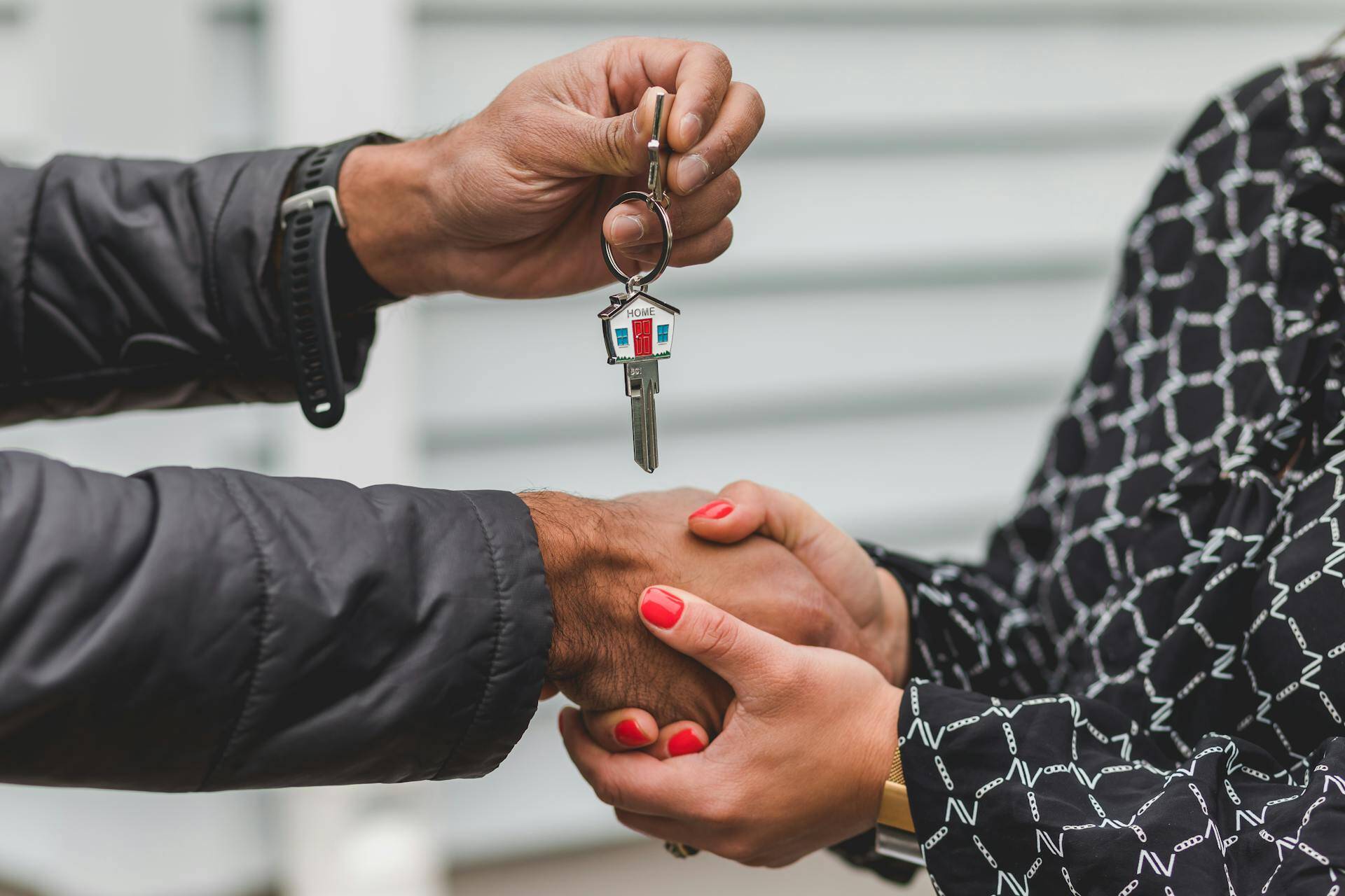 homeowner exchanging keys shaking hands