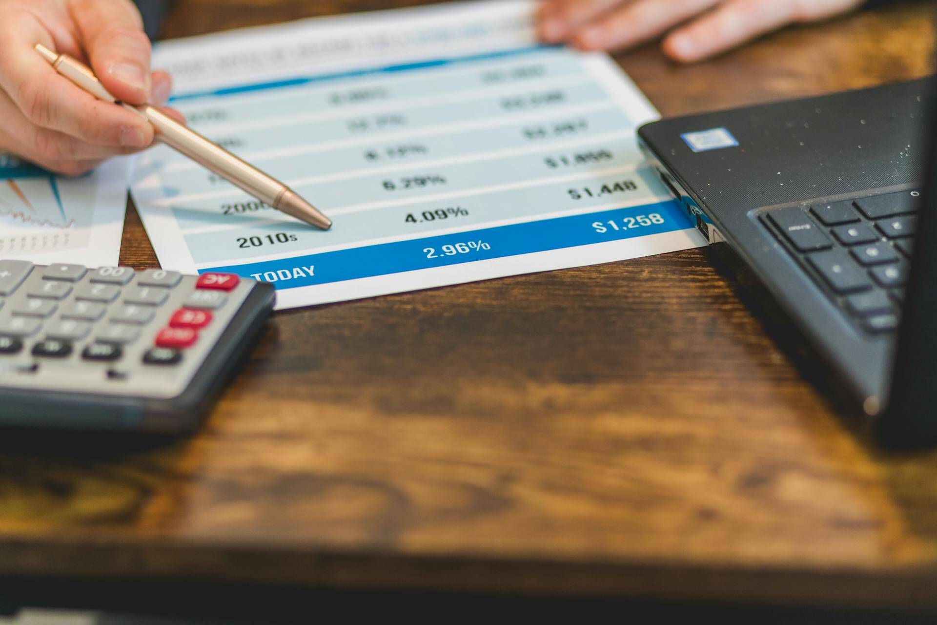 interest rates for homes man with pen pointing at paper with numbers