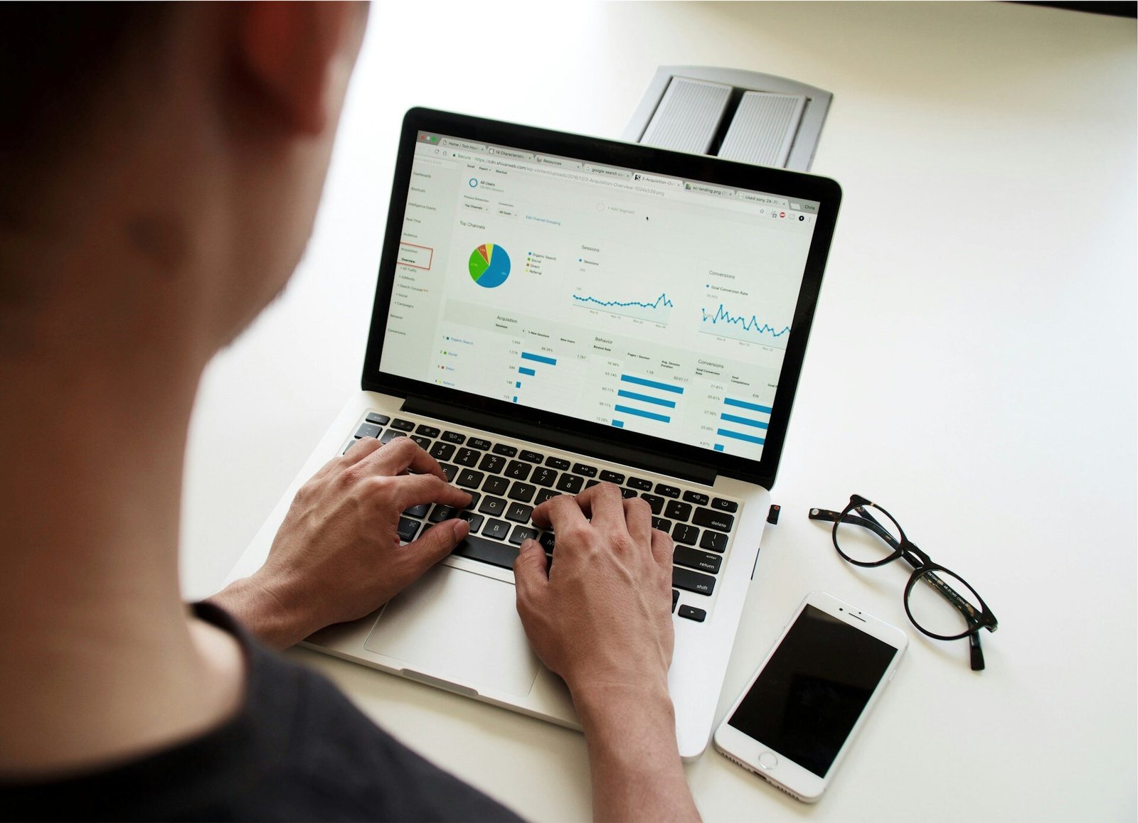 man working on laptop over shoulder shot of analytics for construction industry