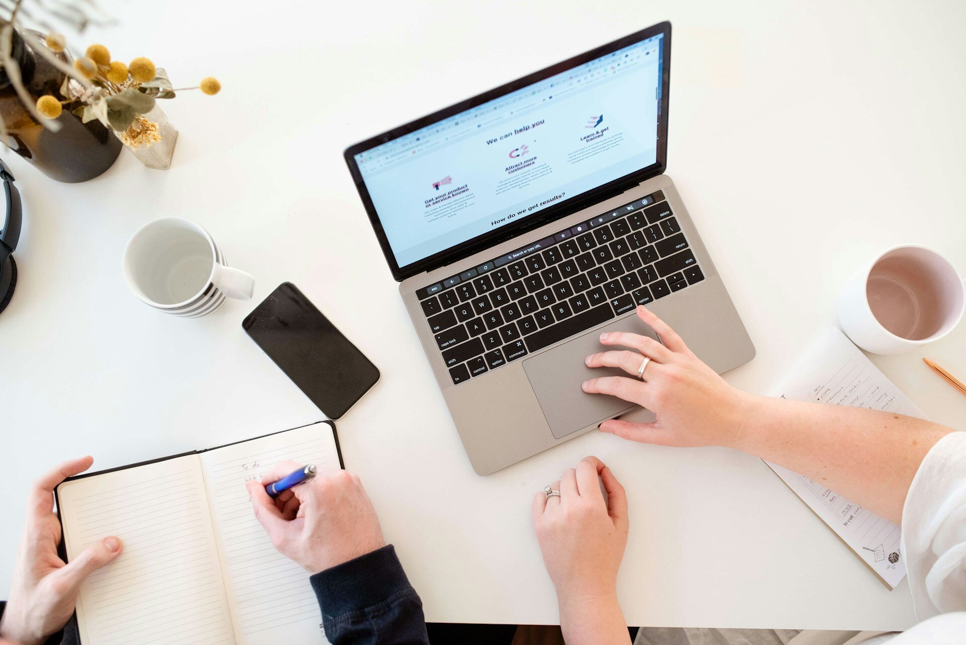 two-people-on-laptop-creating-marketing-plan
